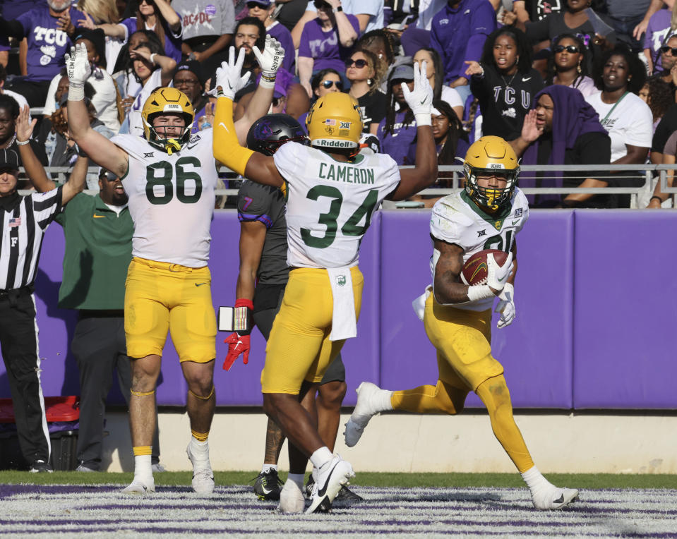 Baylor running back Dominic Richardson, right, scores against TCU in the first half of an NCAA college football game, Saturday, Nov. 18, 2023, in Fort Worth, Texas. (Rod Aydelotte/Waco Tribune-Herald via AP)