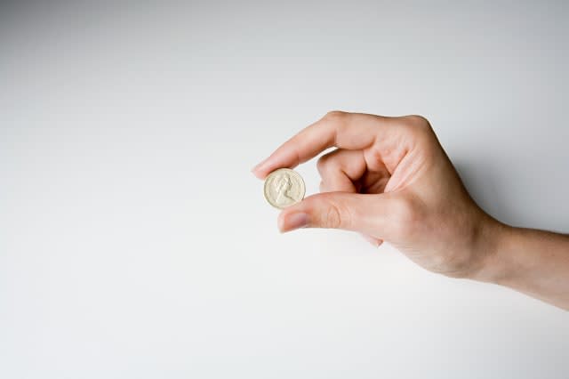 A person holding a pound coin