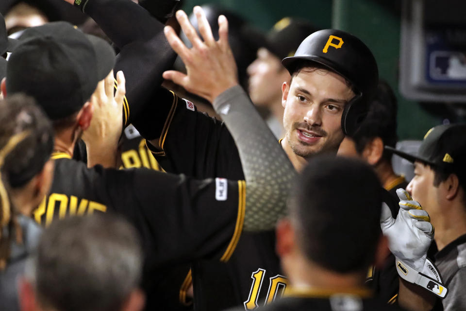 Pittsburgh Pirates' Bryan Reynolds, right, celebrates in the dugout after hitting a three-run home run off Detroit Tigers relief pitcher Nick Ramirez during the sixth inning of a baseball game in Pittsburgh, Wednesday, June 19, 2019. (AP Photo/Gene J. Puskar)