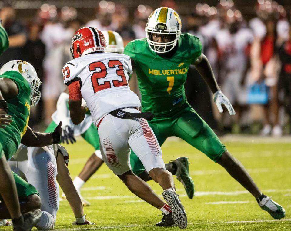 Carver's Jaquavious Russaw (1) sets the edge and tackles Opelika's Kaden Cooper (23) at Cramton Bowl in Montgomery, Ala., on Thursday, Sept. 16, 2021. Opelika leads Carver 14-0 at halftime.