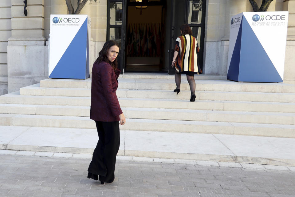 New Zealand Prime Minister Jacinda Ardern, left, leaves after a press conference, at the OECD headquarters, in Paris, Tuesday, May 14, 2019. The leaders of France and New Zealand will make a joint push to eliminate acts of violent extremism from being shown online, in a meeting with tech leaders in Paris on Wednesday. (AP Photo/Thibault Camus)