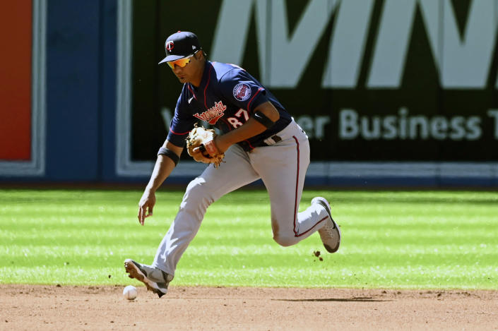 Minnesota Twins' shortstop Jermaine Palacios mishandles a ground ball off the bat of Toronto Blue Jays' shortstop Bo Bichette allowing Cavan Biggio to score from third base during the second inning of a baseball game, Saturday, June 4, 2022 in Toronto. (Jon Blacker/The Canadian Press via AP)