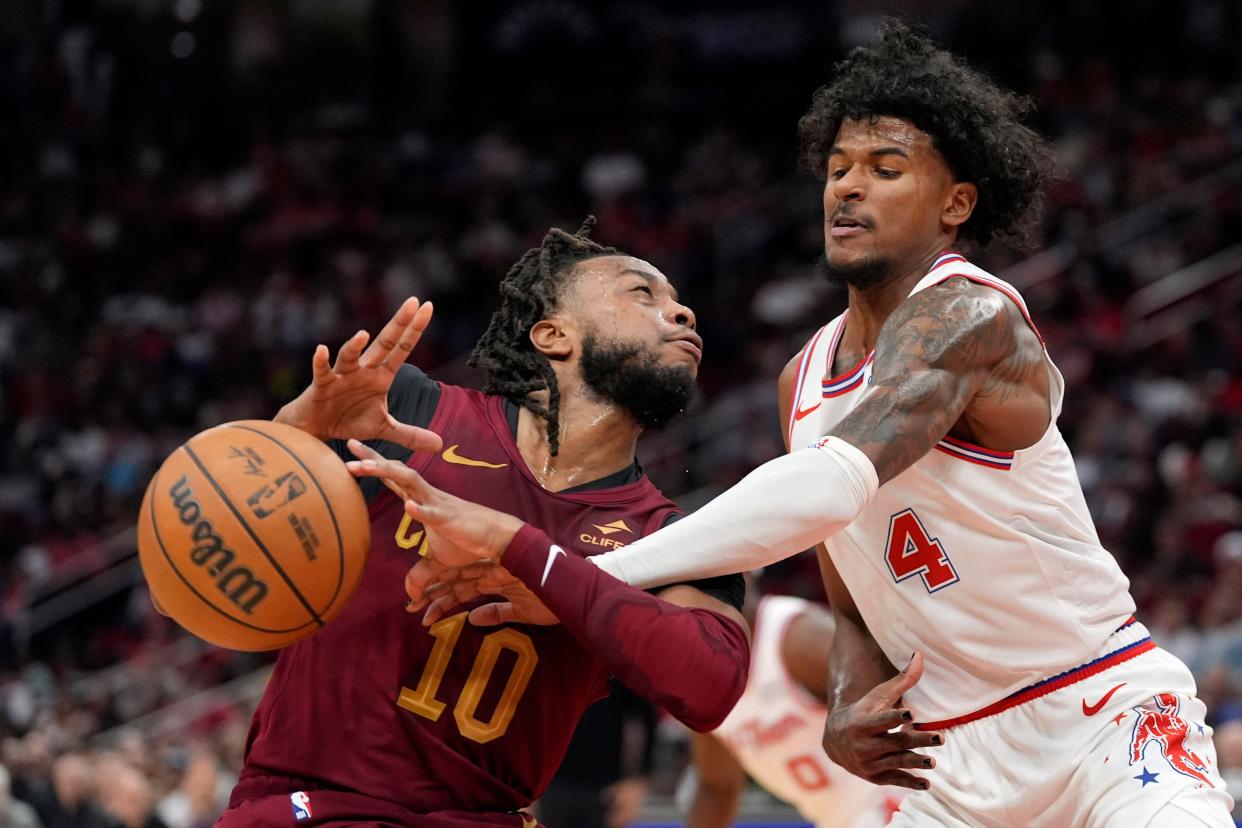 Houston Rockets' Jalen Green (4) knocks the ball loose from Cleveland Cavaliers' Darius Garland (10) on Saturday in Houston.