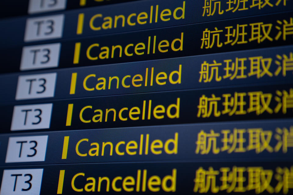 An information board displays cancelled flights at Haneda Airport in Tokyo, Japan. 