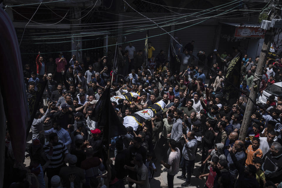 Palestinians carry the bodies of Islamic Jihad commander Ali Ghali and his brother, Mohammed Ghali, which are draped in the militant group's flag, during their funeral in Khan Younis, southern Gaza Strip, Thursday, May 11, 2023. Early on Thursday, the Israeli military killed Ghali, who was said to be commander of the group's rocket force, in an airstrike. (AP Photo/Fatima Shbair)