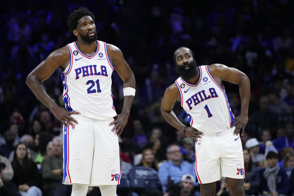 Philadelphia 76ers' Joel Embiid, left, and James Harden watch a free-throw attempt during the second half of an NBA basketball game against the Toronto Raptors, Monday, Dec. 19, 2022, in Philadelphia. (AP Photo/Matt Slocum)