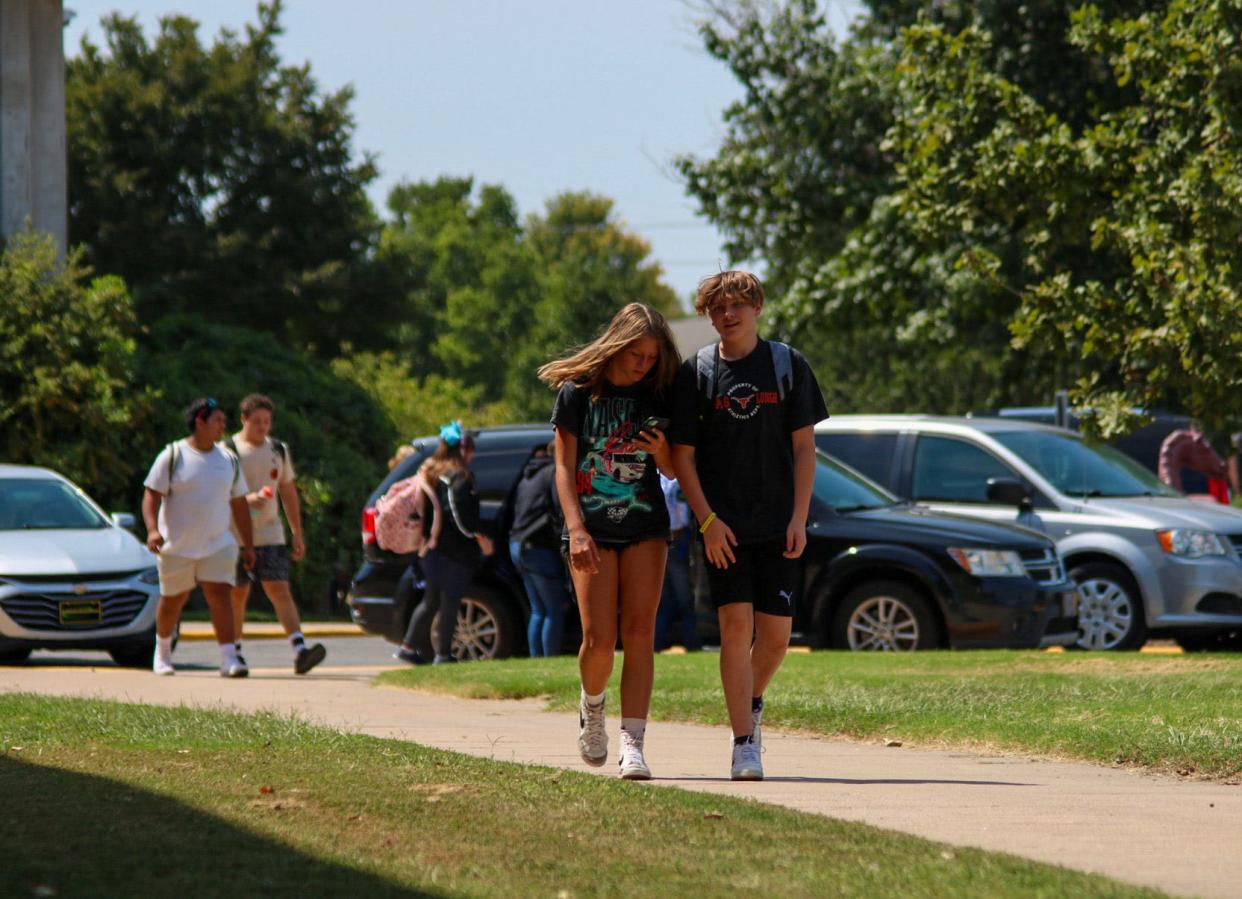 Salina Central freshmen Briley Vallhao (left) and Jesse Lamer (right) walk to their rides after school Aug. 22. Salina Schools is taking precautions for student safety amid an excessive heat advisory.
