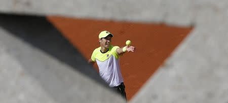 Dusan Lajovic of Serbia serves during the men's singles match against Stan Wawrinka of Switzerland at the French Open tennis tournament at the Roland Garros stadium in Paris, France, May 27, 2015. REUTERS/Jean-Paul Pelissier