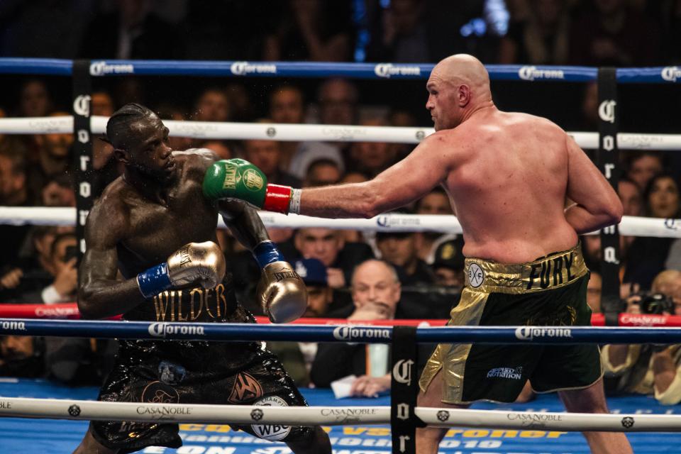 LOS ANGELES, USA - DECEMBER 01: Tyson Fury (R) lands a left hand against Deontay Wilder (L) during WBC Heavyweight Championship at the Staples Center in Los Angeles, California on December 01, 2018.  (Photo by Philip Pacheco/Anadolu Agency/Getty Images)