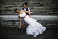 Inae Lee (L) and Jen Chang Ho pose for a picture before taking part in "The Celebration of Love", a grand wedding where over 100 lesbian, gay, bisexual and transgender (LGBT) couples will get married, at Casa Loma in Toronto, June 26, 2014. Toronto is hosting WorldPride, a week-long event that celebrates the LGBT community. REUTERS/Mark Blinch (CANADA - Tags: SOCIETY)