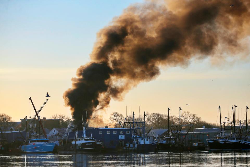 Smoke from the fire aboard the fishing boat Carrabassett docked in Fairhaven can be seen from Popes Island in New Bedford.