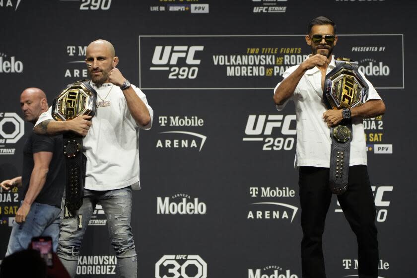 Alexander Volkanovski, left, and Yair Rodriguez react during a news conference for the UFC 290 Mixed Martial arts event Thursday, July 6, 2023, in Las Vegas. The two are scheduled to fight in a featherweight championship bout Saturday in Las Vegas. (AP Photo/John Locher)