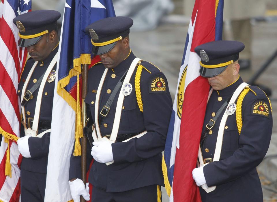 Members of a Dallas Police Department honor guard stand in Dealey Plaza during ceremonies marking the 50th anniversary of JFK's assassination in Dallas