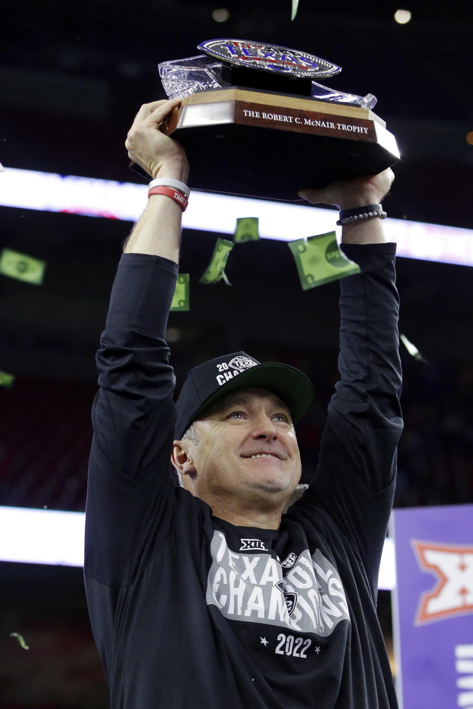 Texas Tech coach Joey McGuire hoists the trophy after the team's 42-25 win over Mississippi in the Texas Bowl NCAA college football game, early Thursday, Dec. 29, 2022, in Houston. (AP Photo/Michael Wyke)