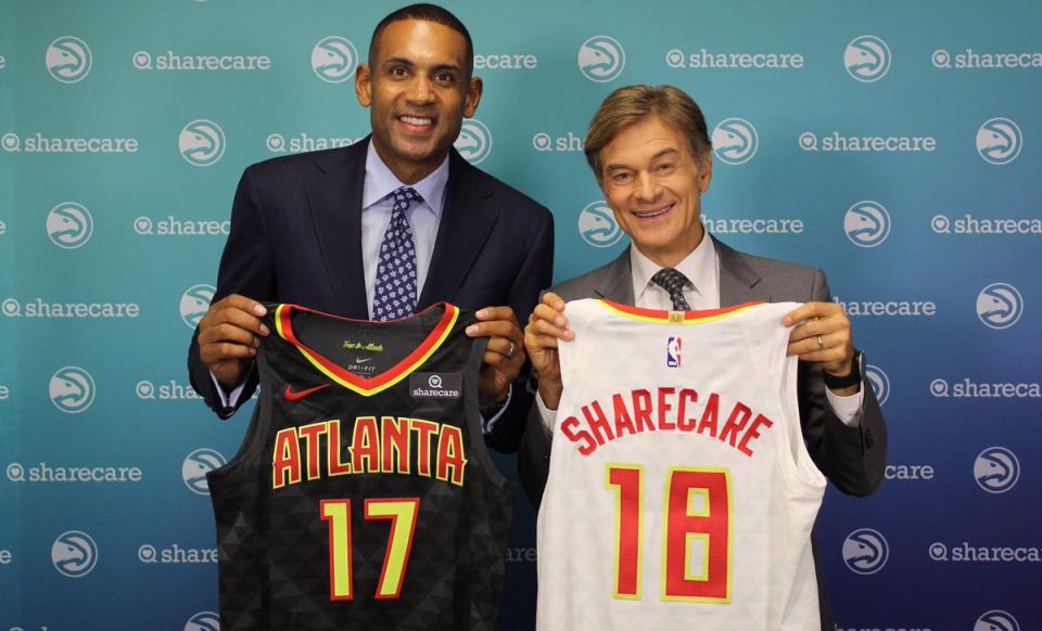 Hawks part owner Grant Hill and Sharecare’s Dr. Mehmet Oz show off Atlanta’s new jersey patch. (Twitter/@ATLHawks)