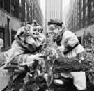 <p>Clowns from the Ringling Brothers Barnum & Bailey Circus, Blinko, left, and Frankie Saluto, right, lend a hand in planting tulips and other flowers in the Channel Gardens of Rockefeller Center in New York, April 7, 1960. The Spring Bulb Show is the first floral displays to be placed in the gardens that are just off Fifth Avenue. (AP Photo/Hans Von Nolde) </p>
