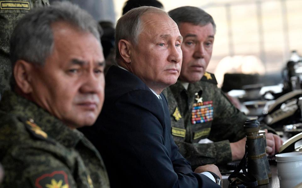 In this photo from 2018, Russian president Vladimir Putin (centre) sits with Russian defence minister Sergei Shoigu (left) and Head of the General Staff of the Armed Forces of Russia Valery Gerasimov (right) in eastern Siberia. - Alexei Nikolsky/Sputnik; The Kremlin