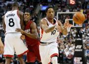 Jan 22, 2016; Toronto, Ontario, CAN; Toronto Raptors guard DeMar DeRozan (10) goes to pass the ball as forward Bismack Biyombo (8) blocks out Miami Heat guard Josh Richardson (0) at the Air Canada Centre. Toronto defeated Miami 101-81. Mandatory Credit: John E. Sokolowski-USA TODAY Sports