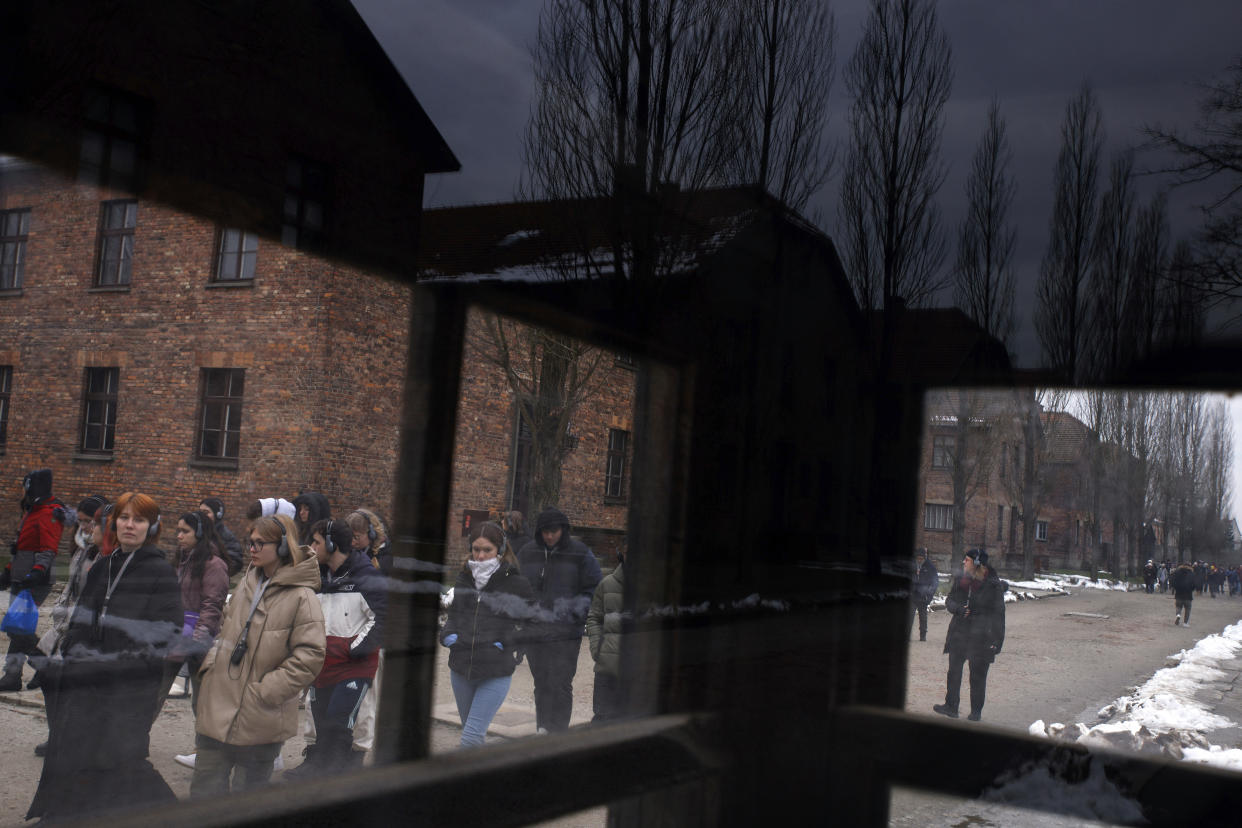 People visit the former Nazi German concentration and extermination camp Auschwitz-Birkenau in Oswiecim, Poland, Thursday, Jan. 26, 2023. Survivors of Auschwitz-Birkenau are gathering to commemorate the 78th anniversary of the liberation of the Nazi German death camp in the final months of World War II, amid horror that yet another war has shattered the peace in Europe. The camp was liberated by Soviet troops on Jan. 27, 1945. (AP Photo/Michal Dyjuk)
