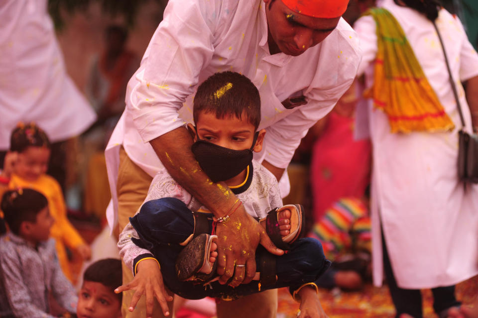 A doctor helps a Child, suffering from Cerebral Palsy, to take part in an event to celebrate the Hindu festival of Holi for the children with cerebral palsy , organised by The Trishla Foundation , in Allahabad on March 6,2020. (Photo by Ritesh Shukla/NurPhoto via Getty Images)