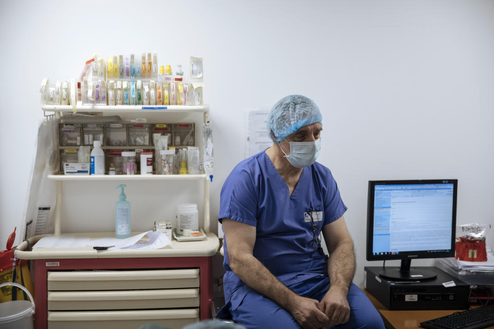 Dr. Philippe Montravers rests in Bichat Hospital, AP-HP, in Paris, Thursday, April 22, 2021. France still had nearly 6,000 critically ill patients in ICUs this week as the government embarked on the perilous process of gingerly easing the country out of its latest lockdown, too prematurely for those on pandemic frontlines in hospitals. President Emmanuel Macron's decision to reopen elementary schools on Monday and allow people to move about more freely again in May, even though ICU numbers have remained stubbornly higher than at any point since the pandemic's catastrophic first wave, marks another shift in multiple European capitals away from prioritizing hospitals. (AP Photo/Lewis Joly)