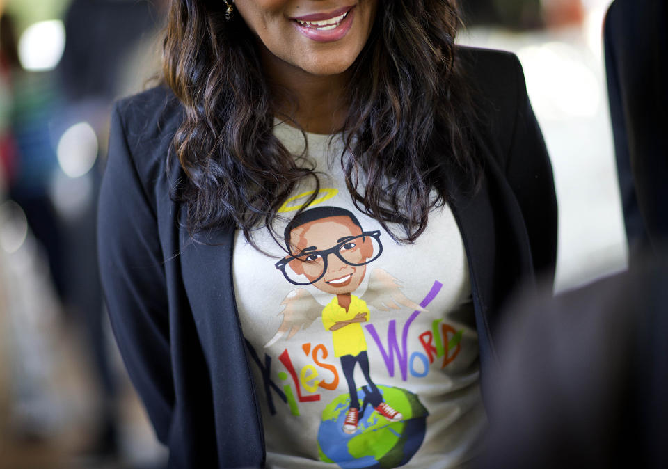 FILE - Tameka Foster, mother of Kile Glover, the stepson of R&B artist Usher, wears a T-shirt decorated with the likeness of her son who died in a boating accident, April 23, 2013, at a ceremony for the signing of a comprehensive boating safety bill in Buford, Ga. Foster is calling to drain Lake Lanier, Georgia's largest lake, where her son was fatally injured 11 years ago. Kile Glover, her 11-year-old son with Bounce TV chairman Ryan Glover, died in July 2012 after a personal watercraft struck the boy as he floated in an inner tube on the lake. (AP Photo/David Goldman, File)