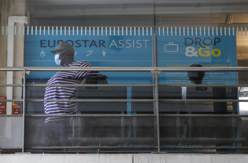 Passengers wait at Eurostar Terminal of the Gare du Nord train station in Paris, Friday, Aug. 14, 2020. British holidaymakers in France were mulling whether to return home early Friday to avoid having to self-isolate for 14 days following the U.K. government's decision to reimpose quarantine restrictions on France amid a recent pick-up in coronavirus infections. (AP Photo/Michel Euler)