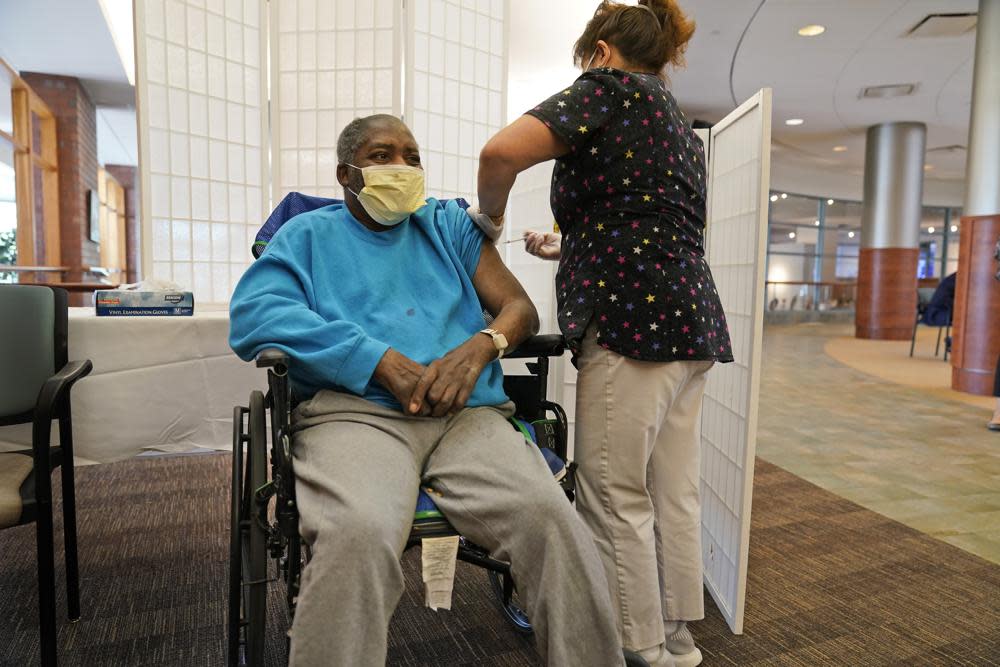 Edward Williams, 62, a resident at the Hebrew Home at Riverdale, receives a COVID-19 booster shot in New York, Sept. 27, 2021. (AP Photo/Seth Wenig, File)