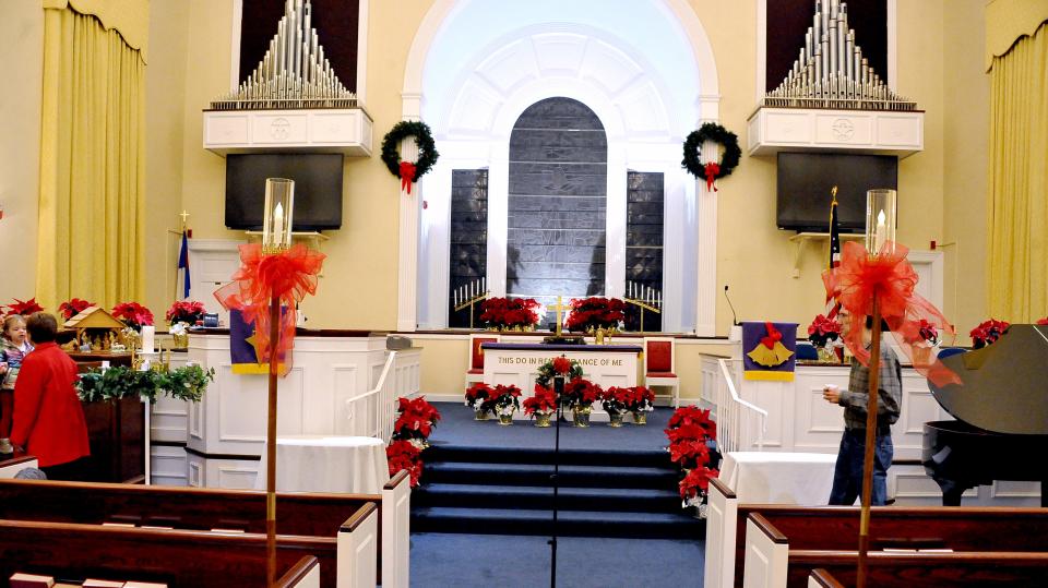 The Central Christian Church sanctuary was decorated with candles and poinsettias.