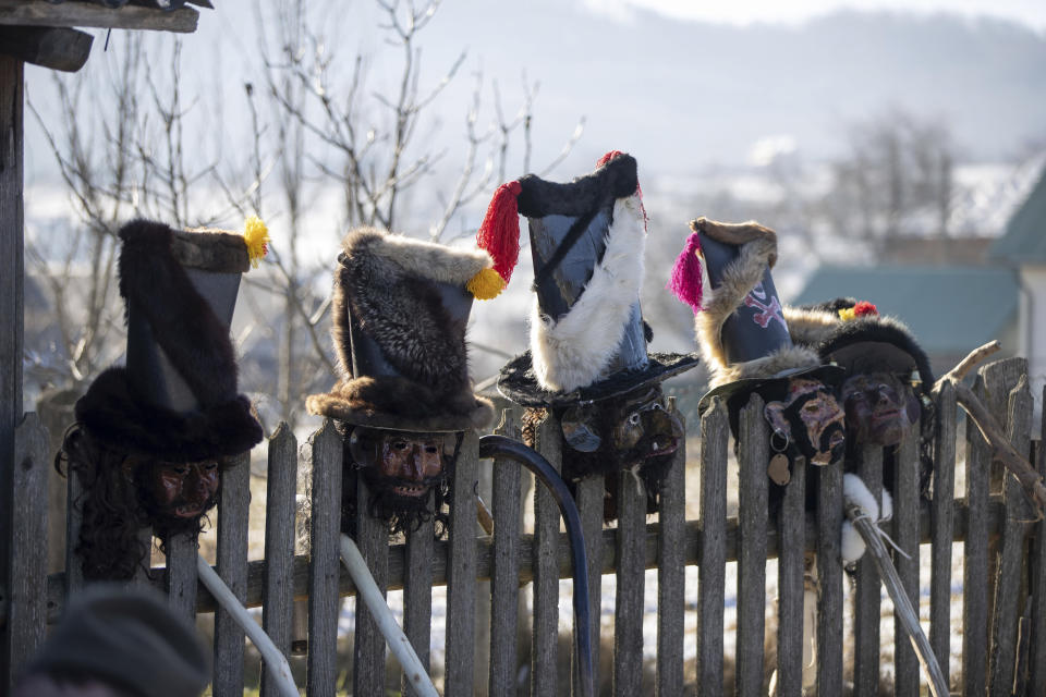 Traditional costume masks used to celebrate the Malanka festival are placed on a fence in the village of Krasnoilsk, Ukraine, Friday, Jan. 14, 2022. Dressed as goats, bears, oxen and cranes, many Ukrainians rang in the new year last week in the colorful rituals of the Malanka holiday. Malanka, which draws on pagan folk tales, marks the new year according to the Julian calendar, meaning it falls on Jan. 13-14. In the festivities, celebrants go from house to house, where the dwellers offer them food. (AP Photo/Ethan Swope)