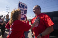 File - Patricia Eckel, left, speaks with Shawn Fain, president of the United Auto Workers, as he visits the picket line at Stellantis' Toledo Assembly Plant in Toledo, Ohio, on Sept. 30, 2023. Armed with a list of what even Fain called “audacious” demands for better pay and benefits, the UAW leader has embodied the exasperation of workers who say they've struggled for years while the automakers have enjoyed billions in profits. (Rebecca Benson/The Blade via AP, File)