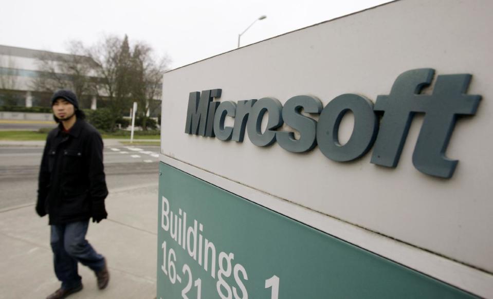 FILE - In this Jan. 22, 2009, file photo, a man walks on the Microsoft headquarters campus in Redmond, Wash. The Justice Department is asking a federal judge to throw out a lawsuit filed by Microsoft that seeks to quash a law allowing the government to demand customer data stored electronically while prohibiting Microsoft from exposing the requests. A justice department lawyer told a federal judge Monday, Jan. 23, 2017, that the government has an interest in keeping criminal investigations confidential. He said Microsoft doesn't have the standing to argue for the Fourth Amendment rights for its customers. (AP Photo/Elaine Thompson, File)