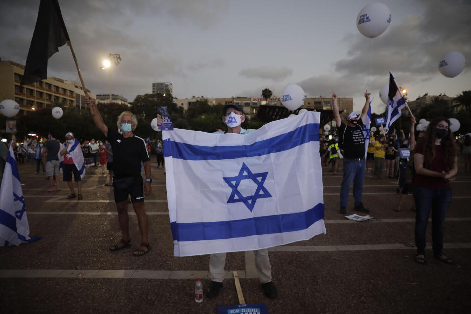 People take part in a protest against Israel's plan to annex parts of the West Bank and Trump's mideast initiative, in Tel Aviv, Israel, Tuesday, June 23, 2020. (AP Photo/Sebastian Scheiner)