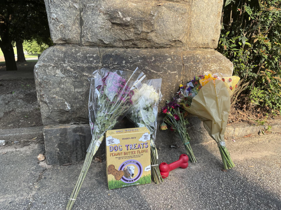 This photo shows a memorial at the Piedmont Park, Wednesday, July 28, 2021 in Atlanta. Authorities are searching for the person who fatally stabbed a woman who was walking her dog in Piedmont Park, one of Atlanta's most popular parks. Katherine Janness, 40, was found dead in Piedmont Park around 1 a.m. Wednesday, police said. Her dog had also been killed. (AP Photo/R.J. Rico)