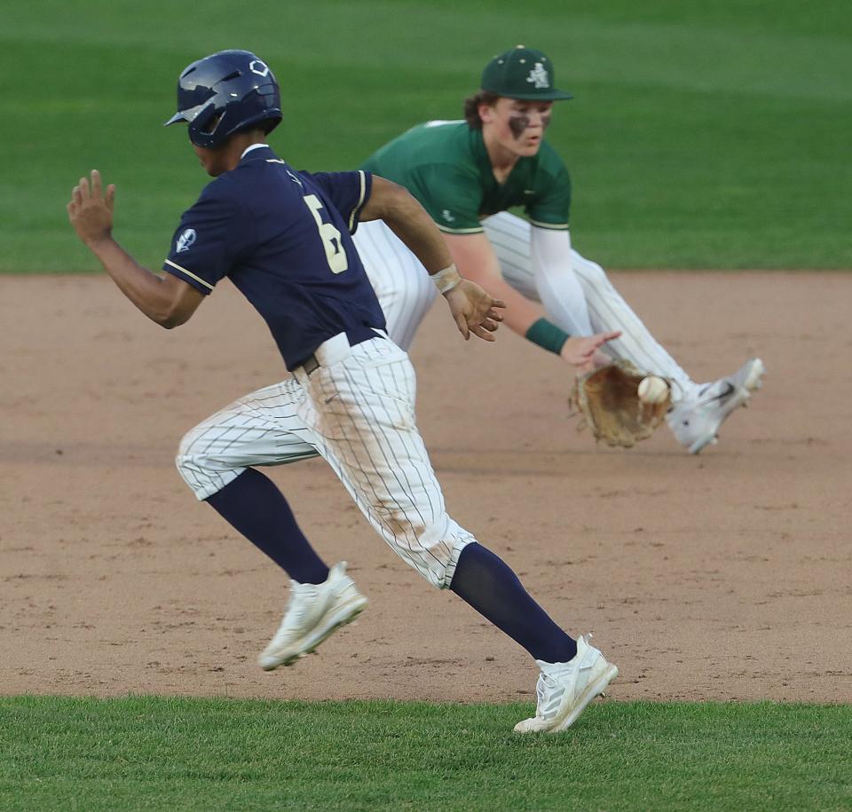 Archbishop Hoban sophomore Masud Jennings advances to second base as St. Vincent-St. Mary second baseman Devon Lehman makes the stop on a groundball on Sunday April 24, 2022 at Canal Park in Akron, Ohio.