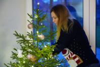 Katrin Sagur decorates Christmas tree found with help of a mobile application in Kuuresaare