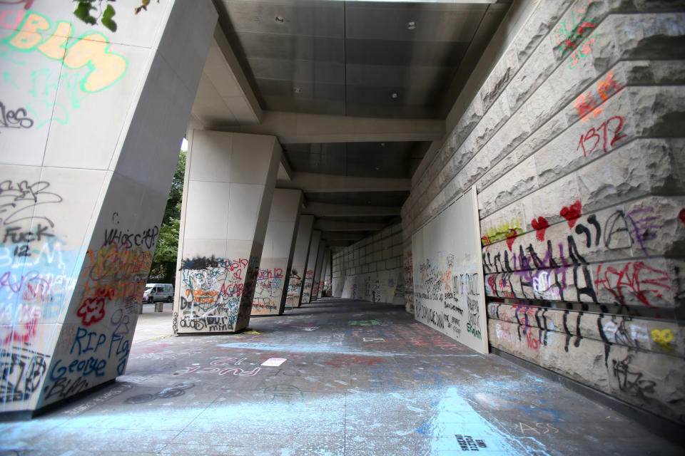 An exterior shot of the Mark O. Hatfield United States Courthouse, which has been covered in graffiti during nightly protests, in downtown Portland on Sunday, July 12, 2020. (Sean Meagher/The Oregonian via AP)