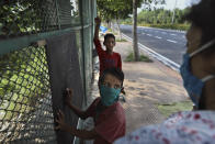 Veena Gupta takes a class for underprivileged children on a sidewalk in New Delhi, India, on Sept. 3, 2020. Veena Gupta and her husband are conducting free classes for underprivileged children on a sidewalk in New Delhi with the goal to keep them learning and not left behind when schools reopen. As most schools in India remain shut since late March when the country imposed a nationwide lockdown to curb the spread of COVID-19, many switched to digital learning and taking classes online. (AP Photo/Manish Swarup)