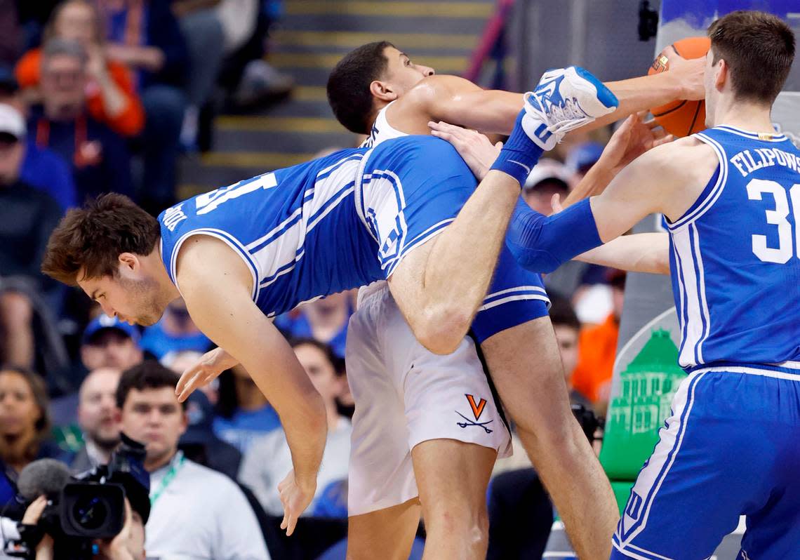 Duke’s Ryan Young (15) fouls Virginia’s Kadin Shedrick (21) during the second half of Duke’s 59-49 victory over Virginia to win the ACC Men’s Basketball Tournament in Greensboro, N.C., Saturday, March 11, 2023.