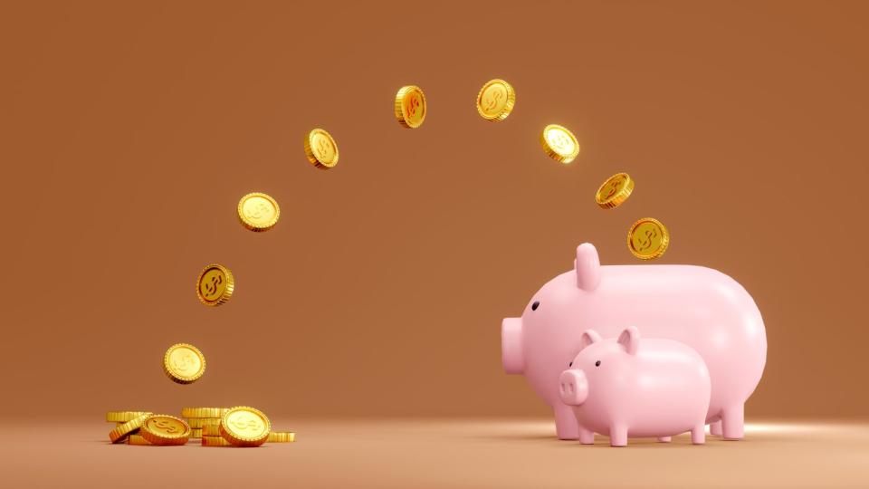 Coins flying into two piggy banks.