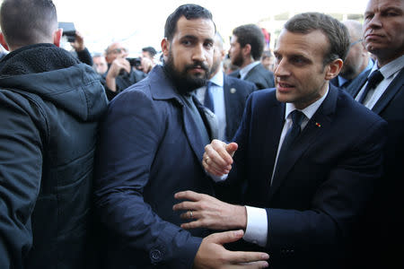 Elysee senior security officer Alexandre Benalla stands next to French President Emmanuel Macron during a visit to the Paris International Agricultural Show (Salon de l'Agriculture) in Paris, France, February 24, 2018. REUTERS/Stephane Mahe/Pool/File Photo