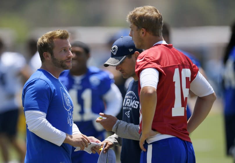 FILE - In this June 5, 2017, file photo, Los Angeles Rams coach Sean McVay, left, talks with quarterback Jared Goff, right, as offensive coordinator Matt LaFleur stands between them during NFL football practice in Thousand Oaks, Calif. Green Bay Packers coach LaFleur and Rams coach McVay say their friendship and shared history shouldn't have much of an impact on their teams' upcoming NFC divisional playoff matchup. (AP Photo/Mark J. Terrill, File)