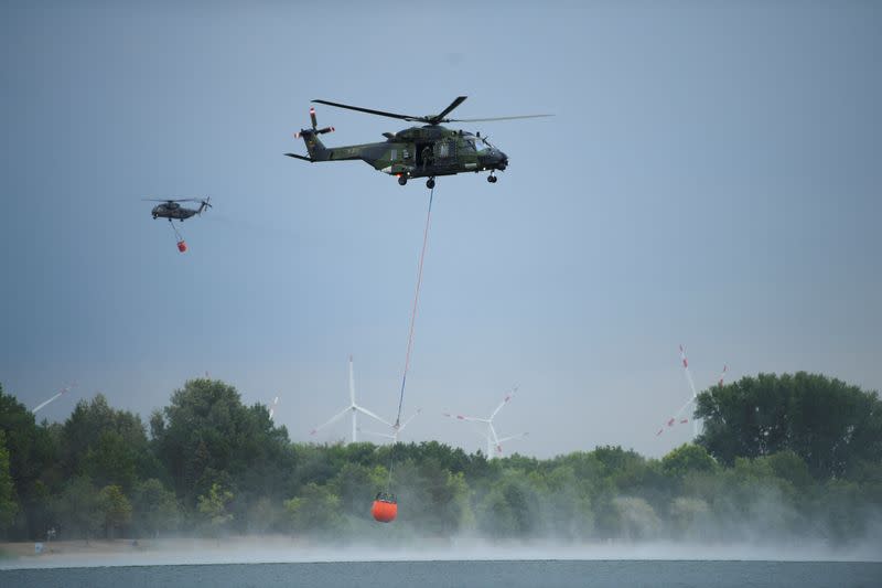 Firefighters work to extinguish a forest fire in Falkenberg