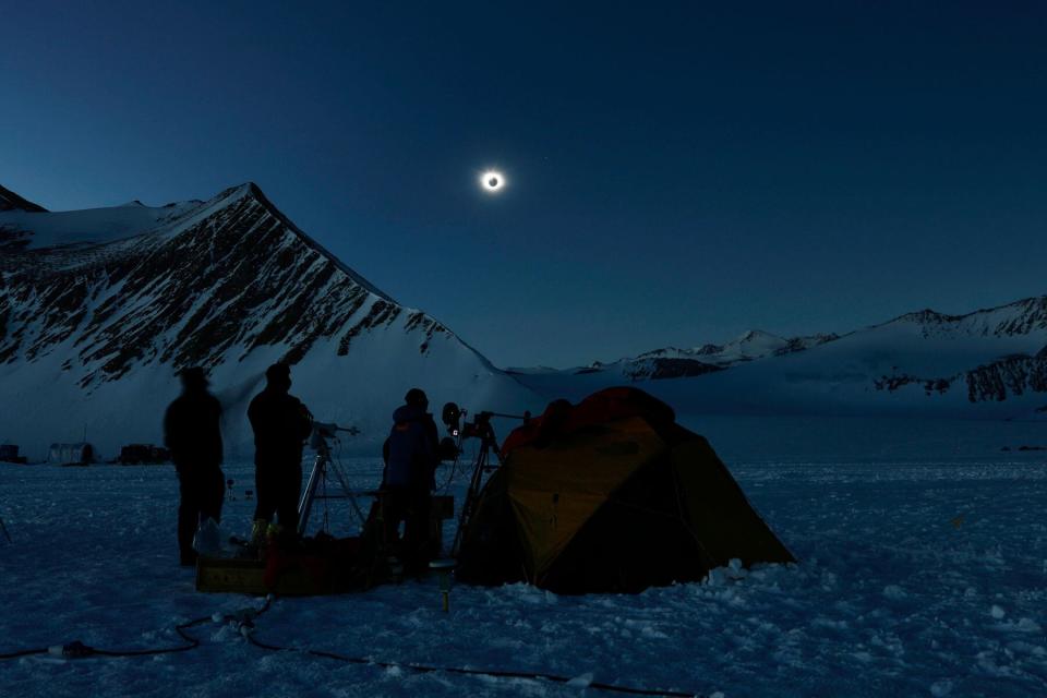 Chilean and US scientists looking at a solar eclipse from the Union Glacier in Antarctica on December 4, 2021.