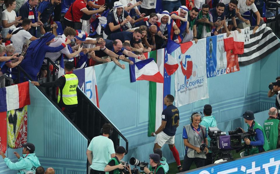 Following his second goal, Kylian Mbappe leapt over the advertising boards to soak up the French adulation - Marko Djurica/Reuters