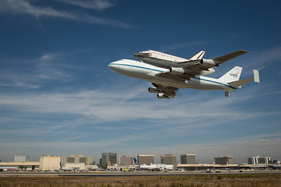 Space shuttle Endeavour, mounted atop a NASA 747 Shuttle Carrier Aircraft (SCA) performs a low flyby at Los Angeles International Airport, Friday, Sept. 21, 2012. Endeavour, built as a replacement for space shuttle Challenger, completed 25 miss