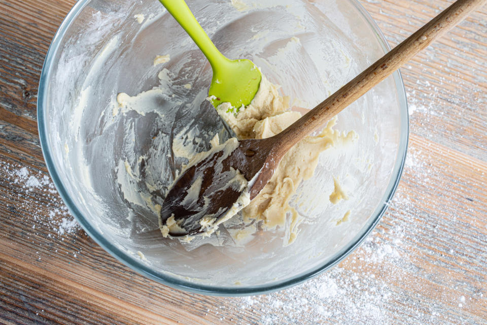 A wooden spoon and silicon spatula in a bowl