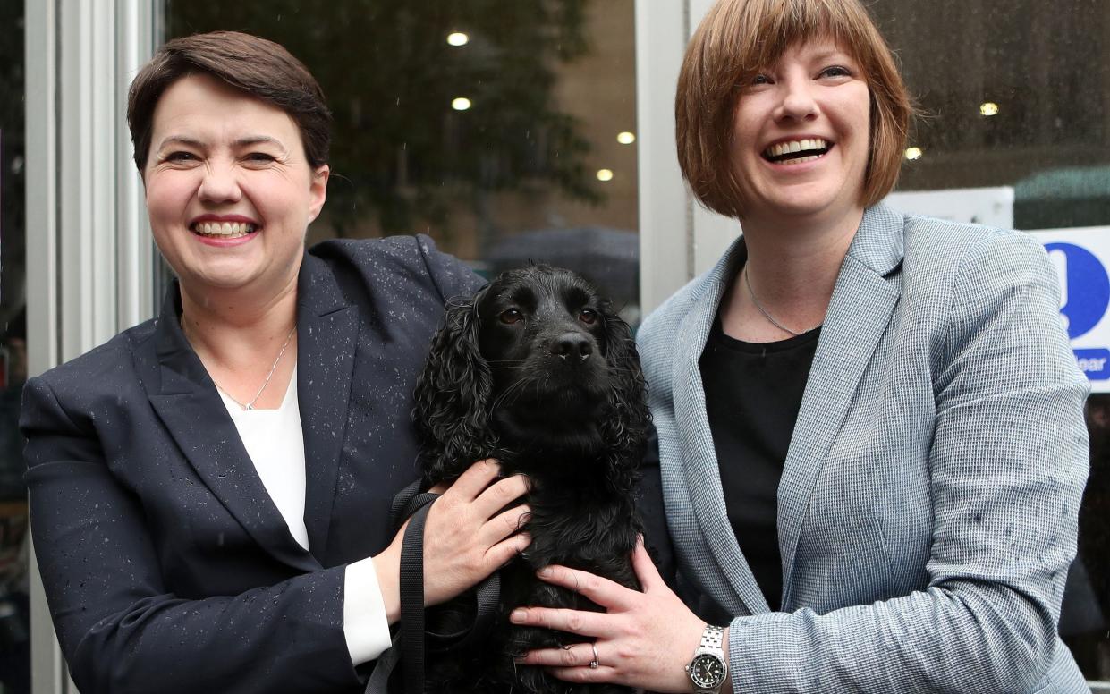 Scottish Conservative leader, Ruth Davidson (L), poses with her partner Jen Wilson and their dog Mister Wilson - AFP