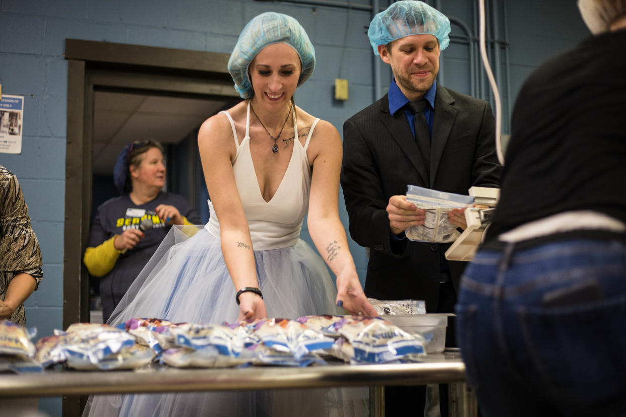 “I can’t dance, but I can pack,” Adam Claude said of packing meals with new bride Chara Juneau and their charity hall wedding. (Photo: Courtesy of Feed My Starving Children)