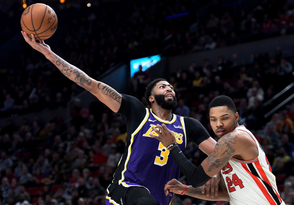 Anthony Davis #3 of the Los Angeles Lakers loses control of the ball as he goes up for a shot over Kent Bazemore.